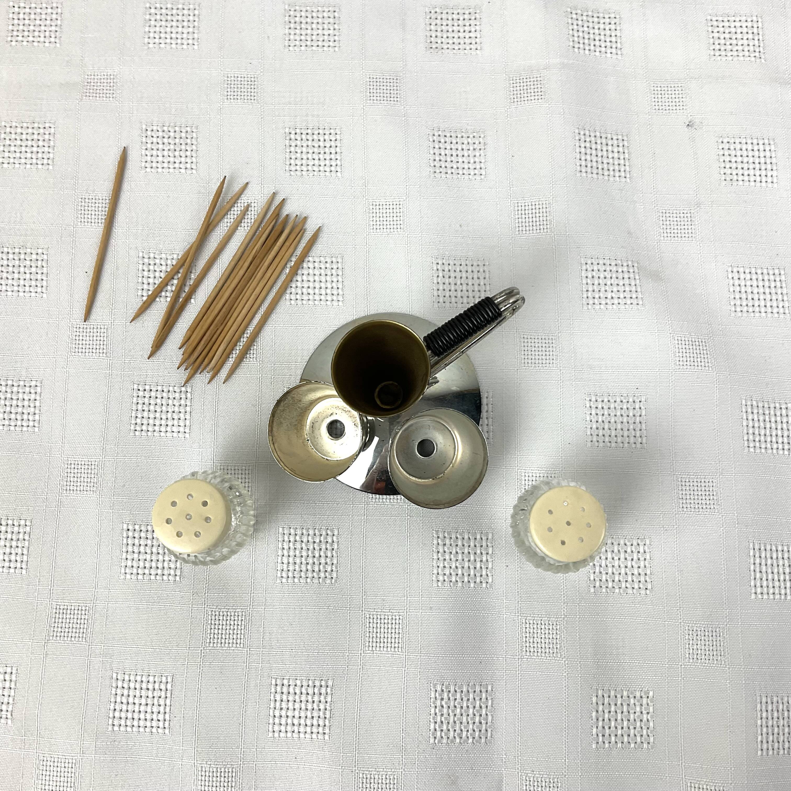 Vintage salt and pepper shakers and their chrome metal support