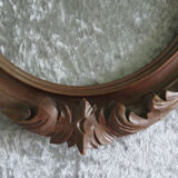 Wooden oval frame with carved pediment