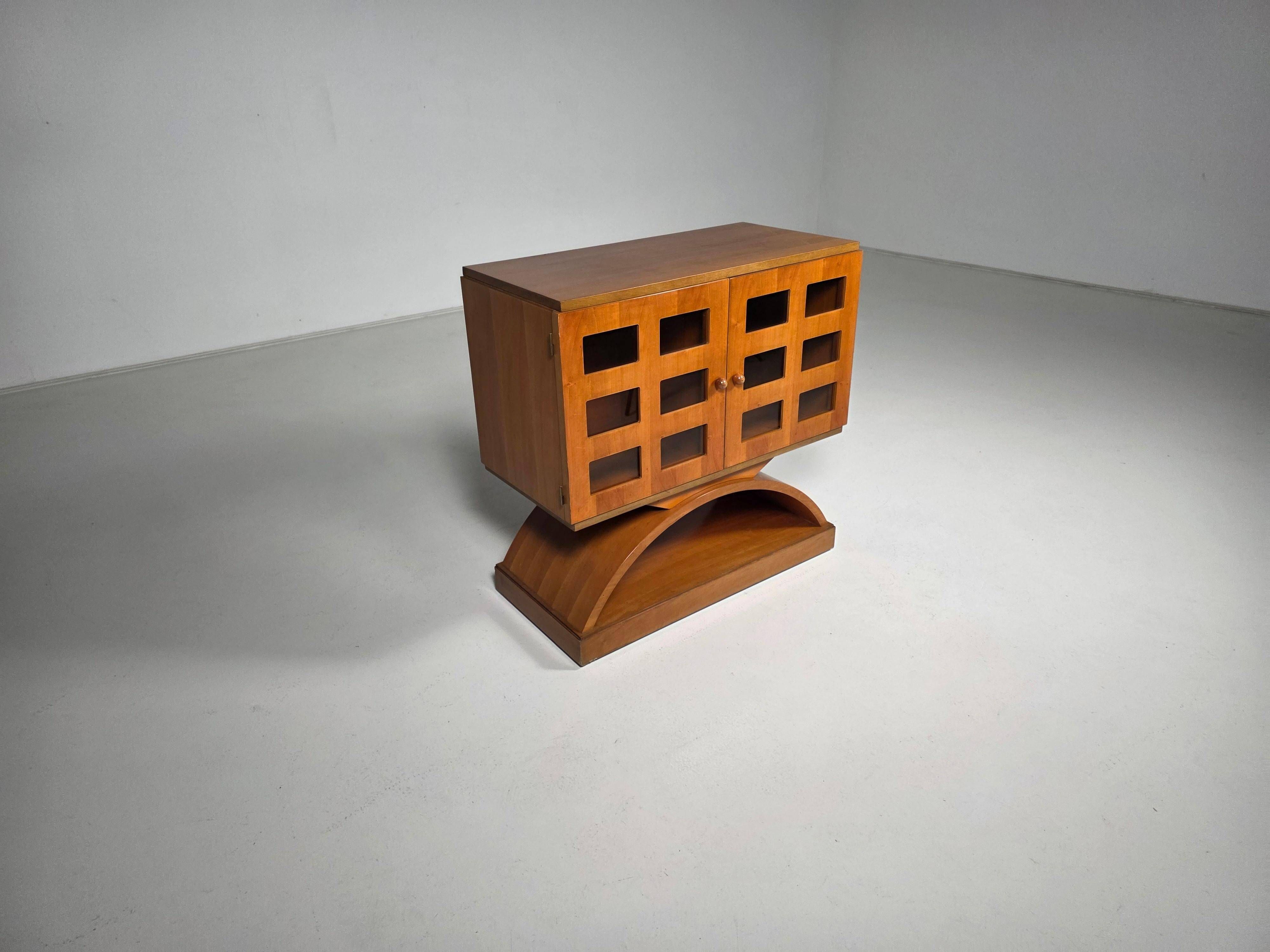 Mid-century modern mobile bar cabinet with sculptural base, 1950s.