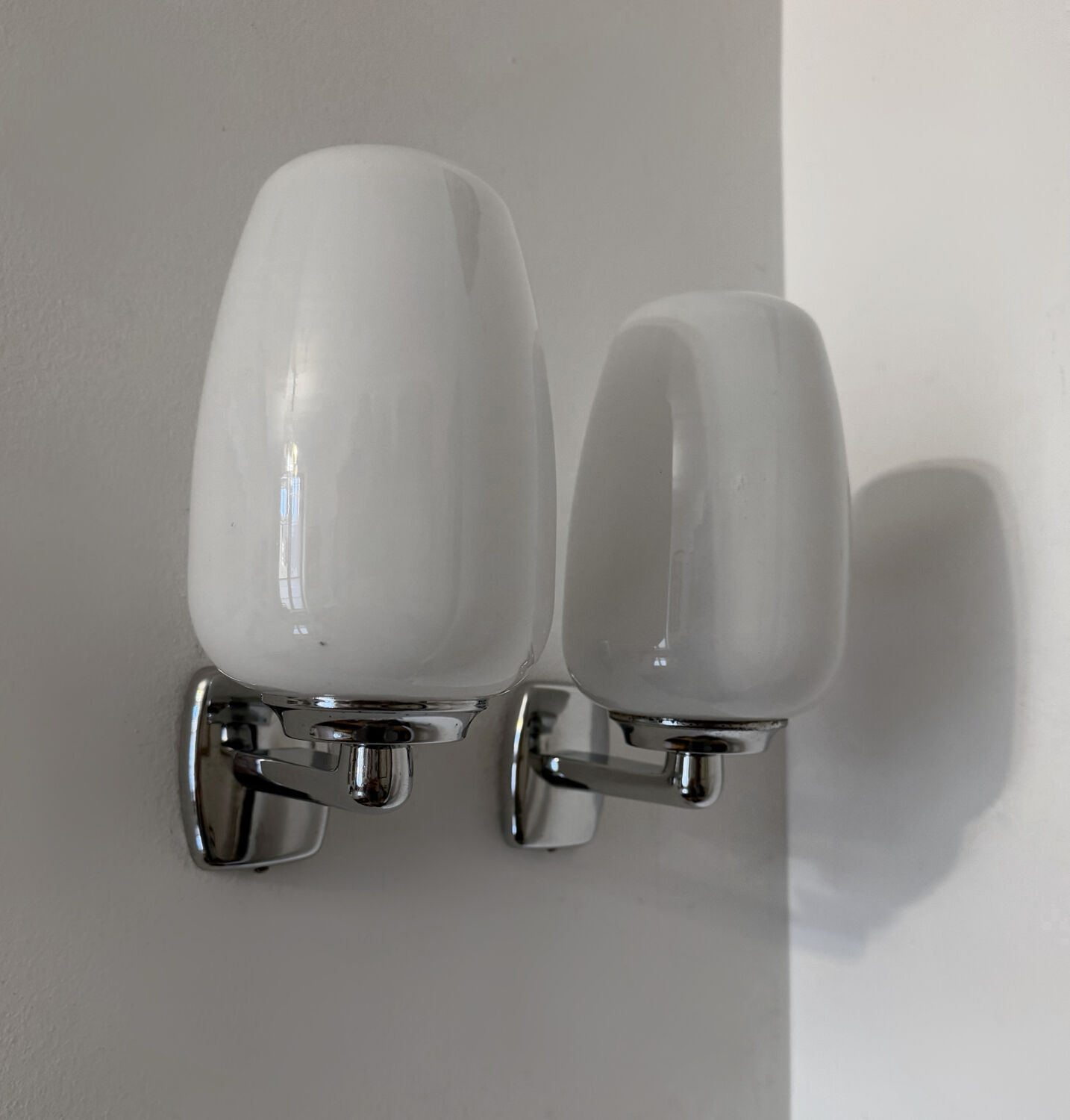 Chrome and opaline wall lights from the 70s.