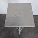 Tripod sculptor's stool in grey painted wood with a rotating top.