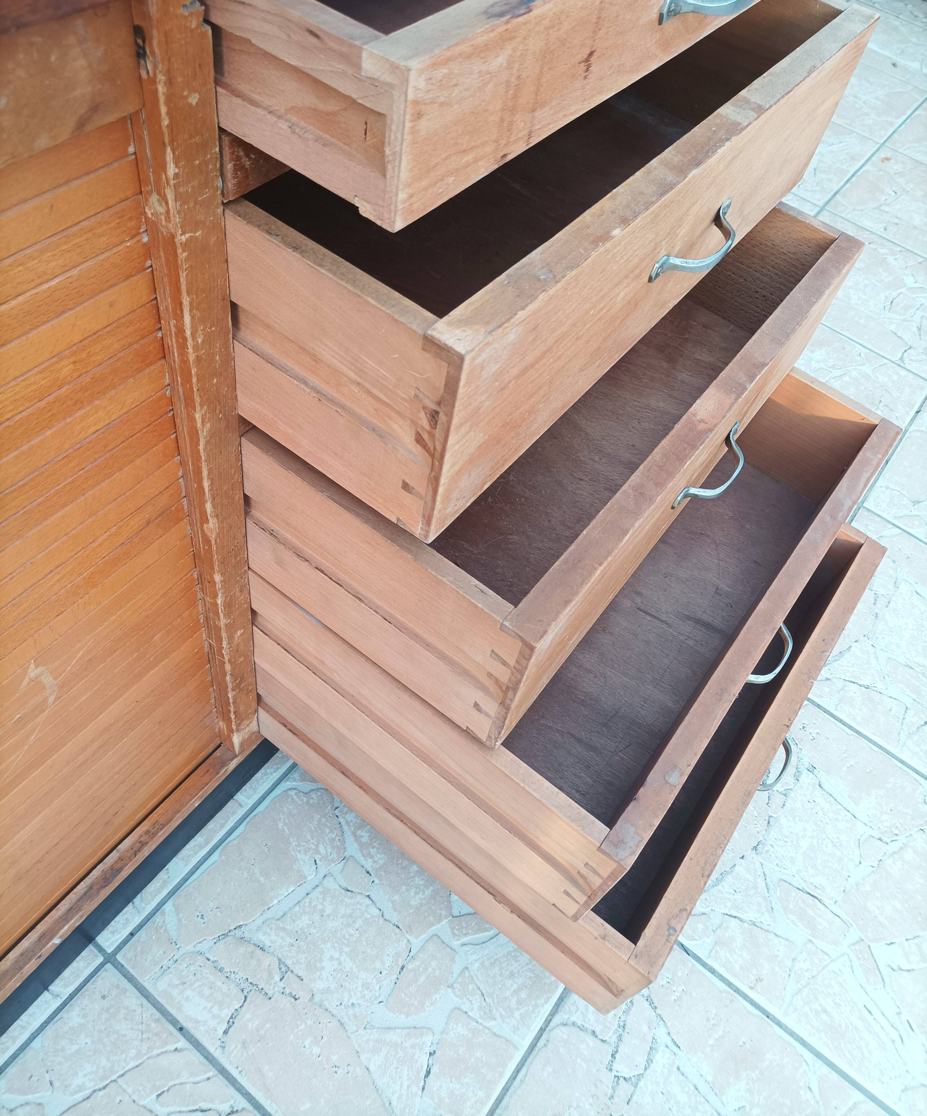 Workshop furniture with drawers and curtain in beech and walnut.