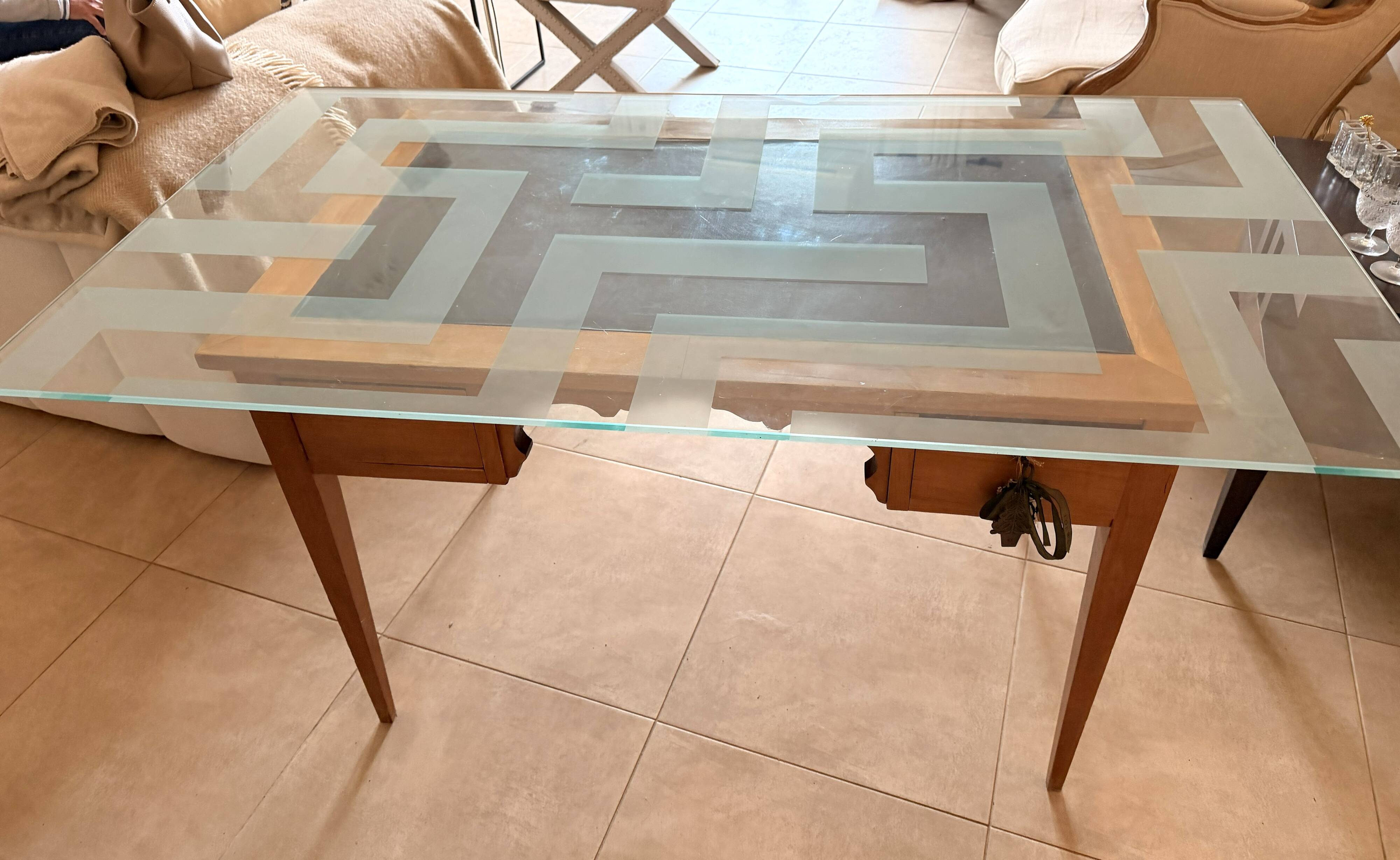 Elegant antique desk in cherry wood with a black leather top and glass plate.
