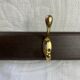 Wooden coat rack with double brass hooks