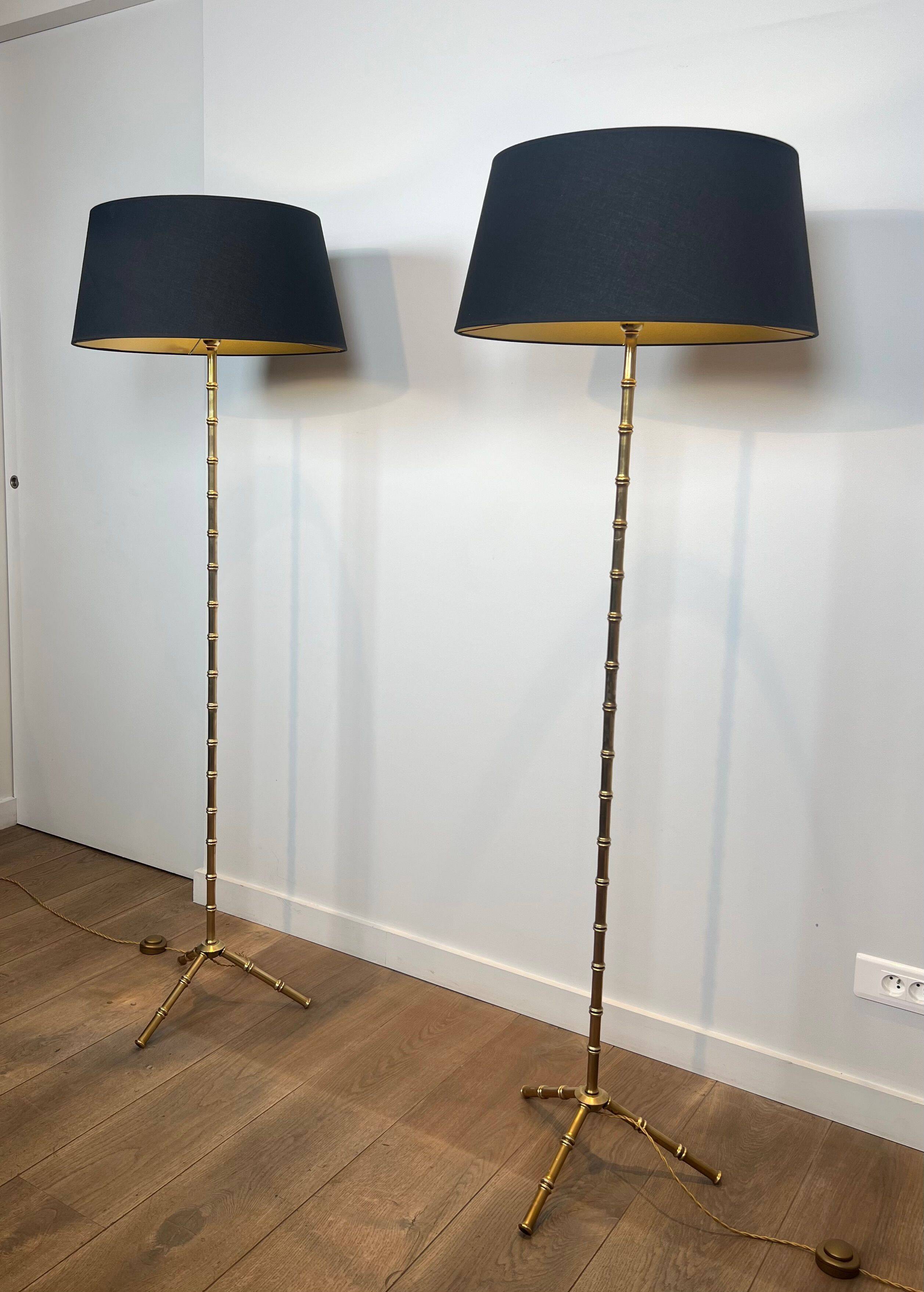 Pair of parquet floor lamps in faux-bamboo style in bronze and brass by Jacques Adnet.