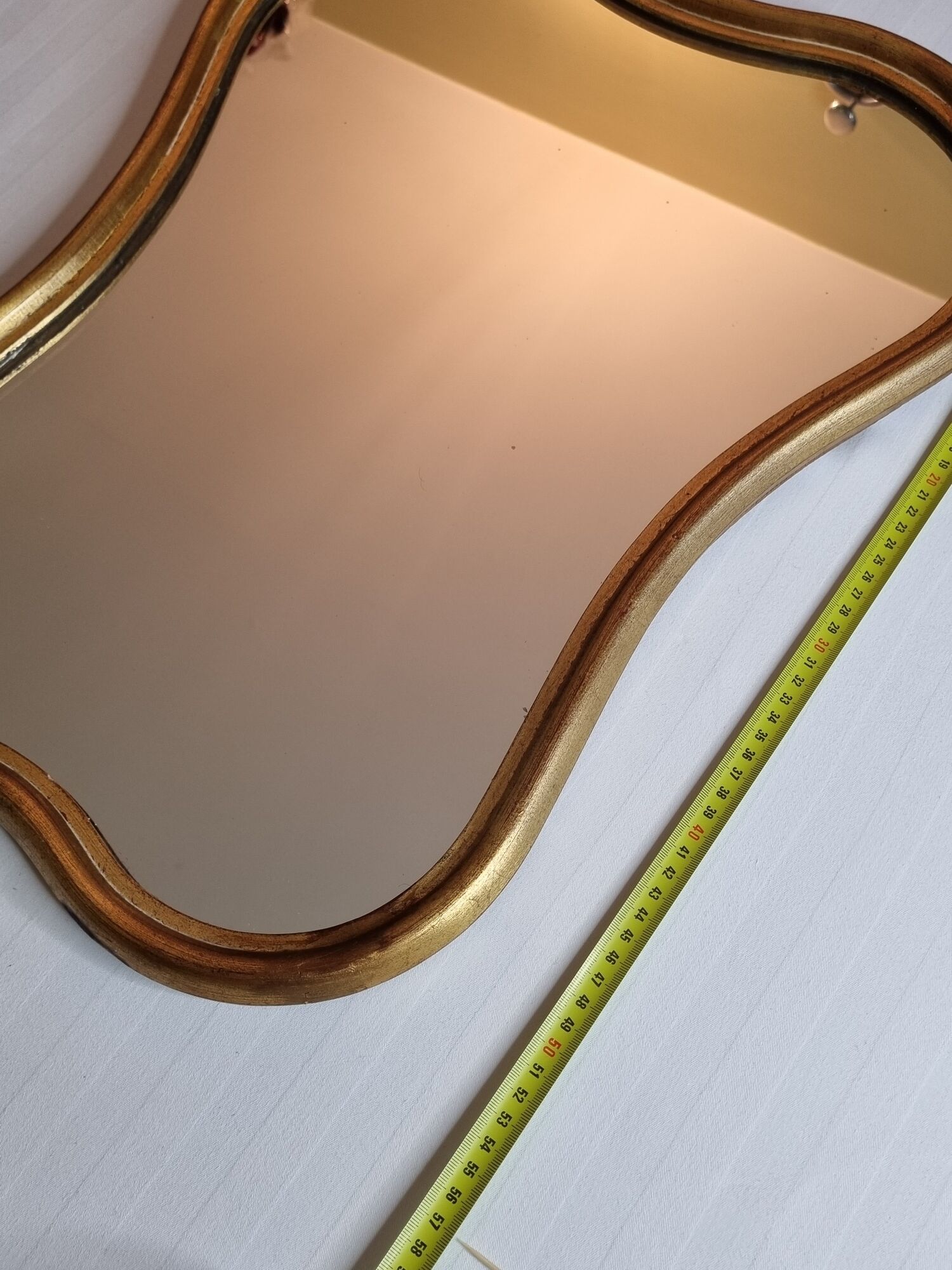 Vintage baroque style mirror, with curved frame in stucco and gilded wood 57 cm
