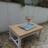 Coffee table with pearl grey legs and a wooden top.