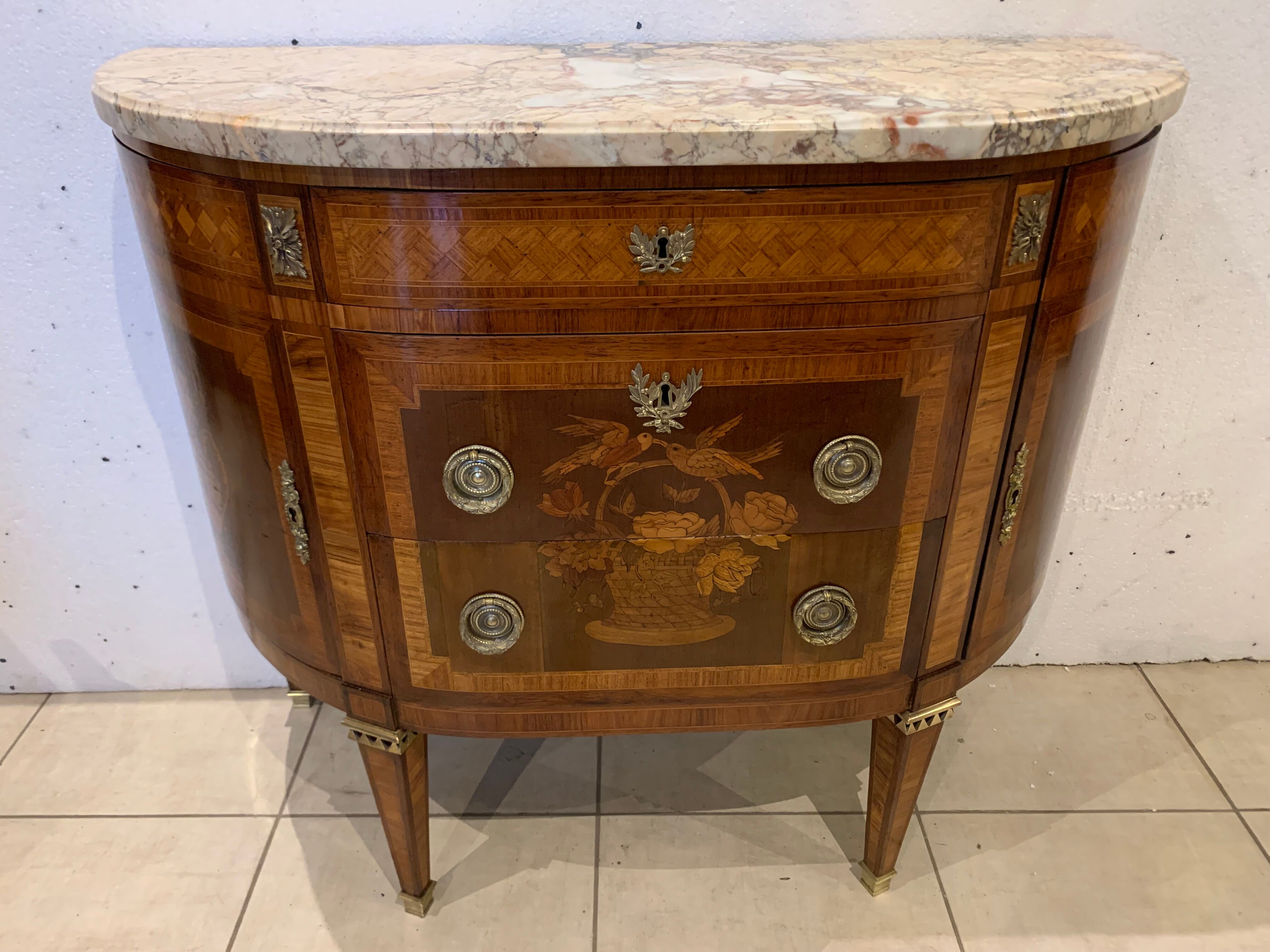 Louis XVI style half-moon chest of drawers in late nineteenth century marquetry
