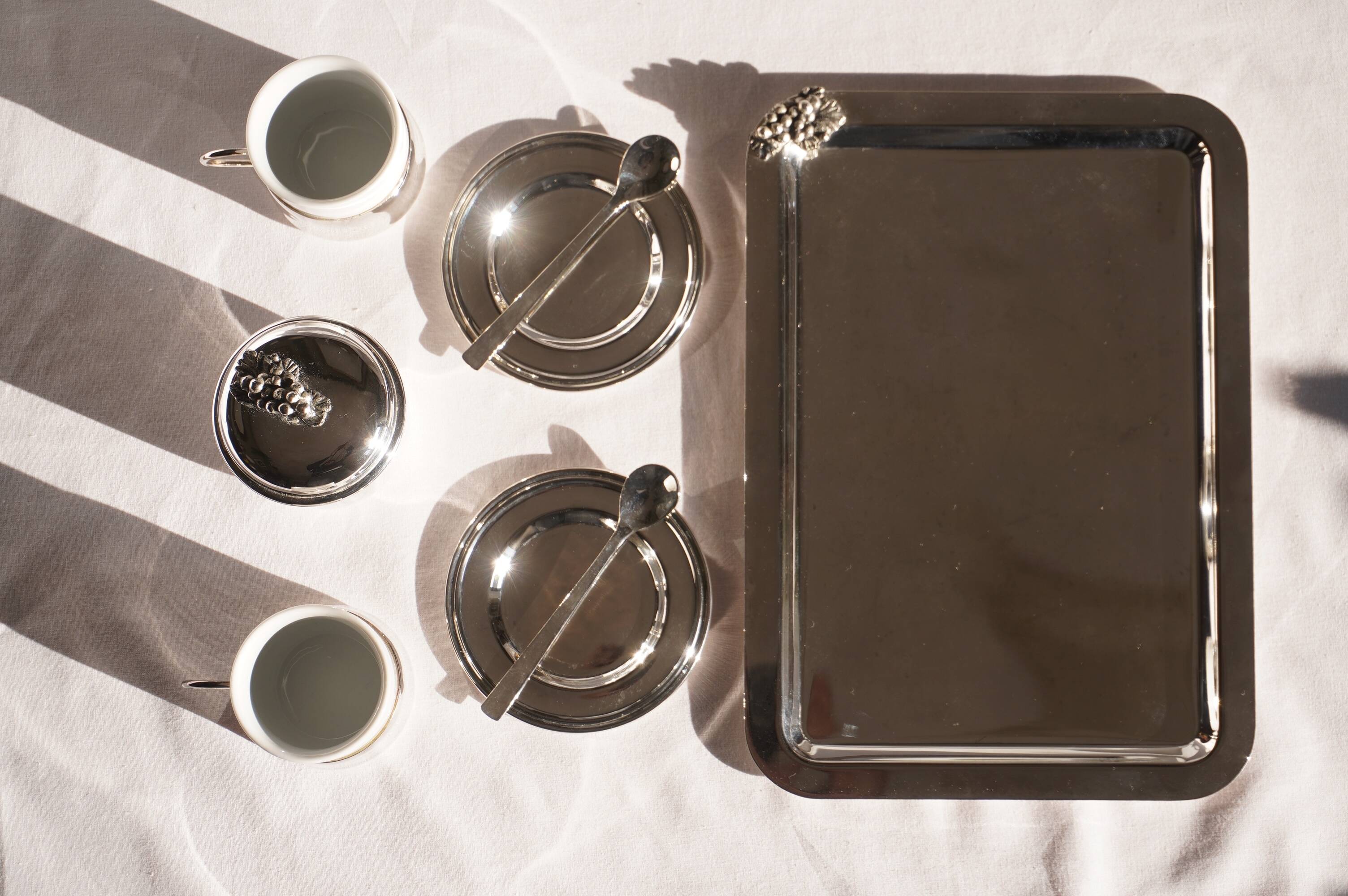 Silver-plated metal coffee service with a grape design.