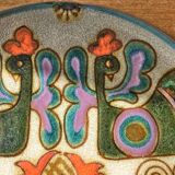 Vintage ceramic plate with peacock bird decoration.