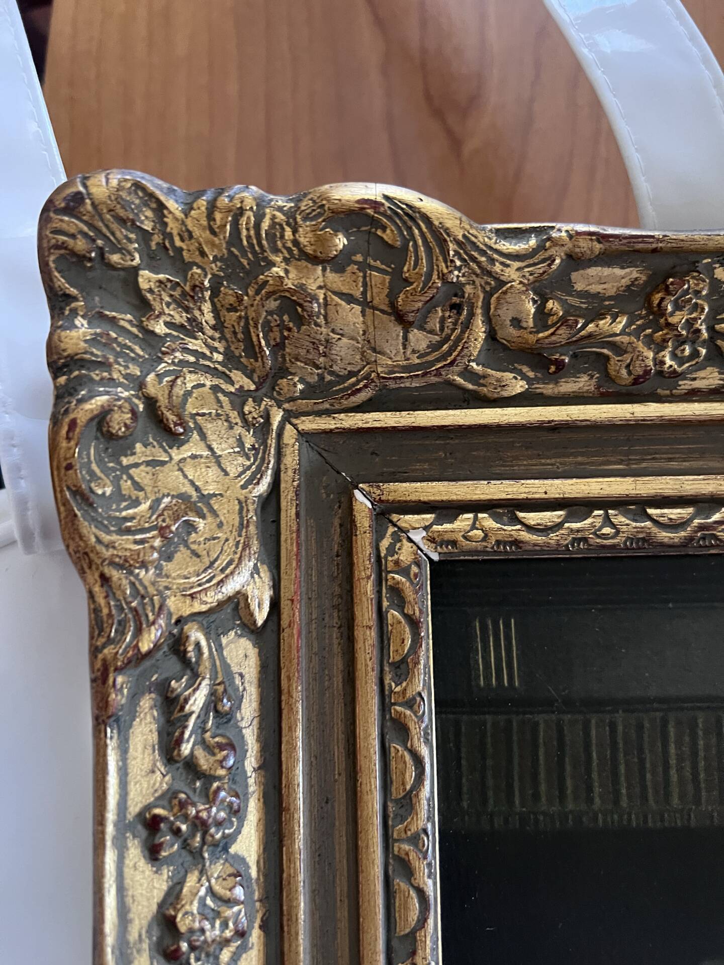 Framed reproduction painting with a golden frame.