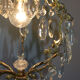 Old brass chandelier with glass stamps