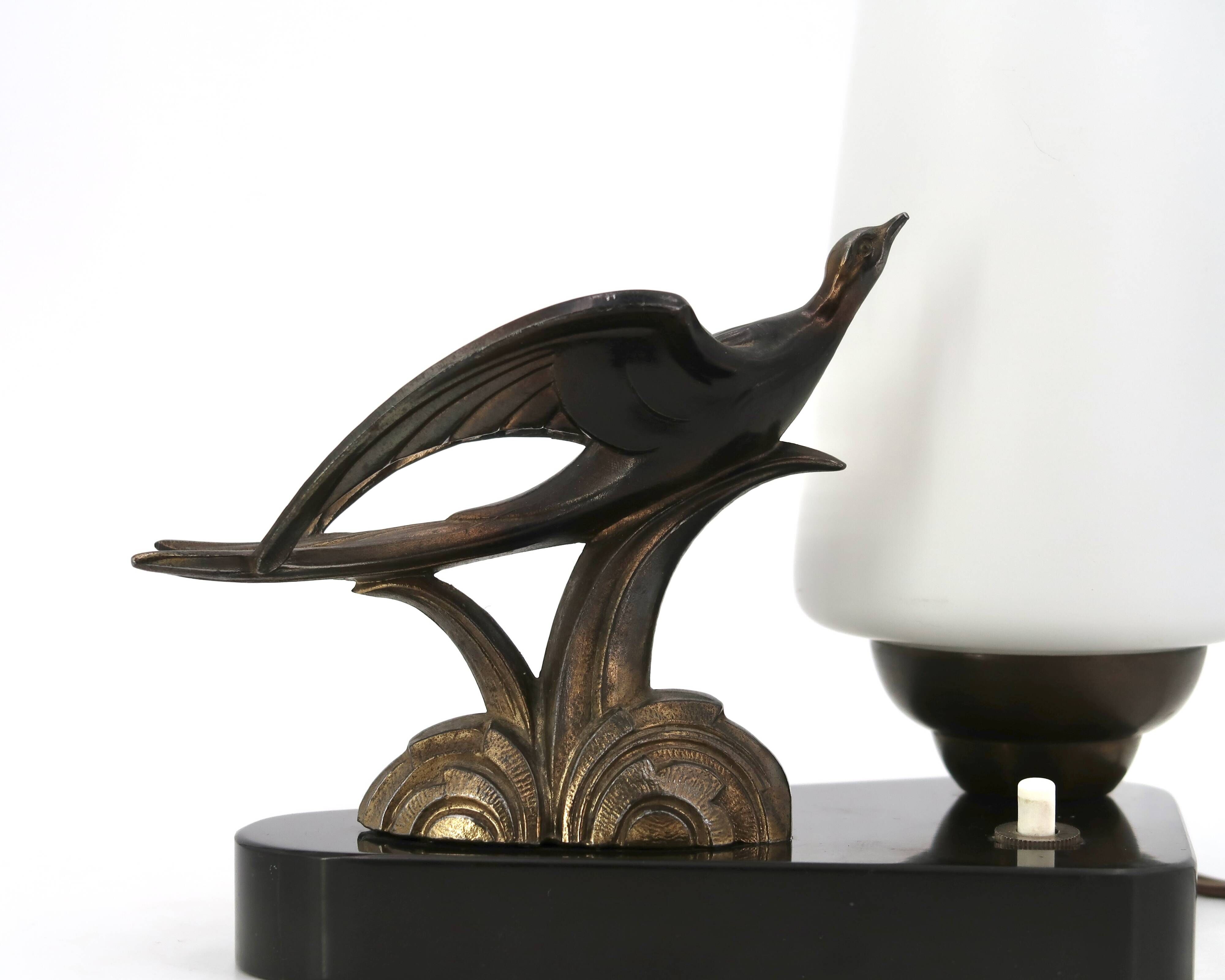 Art Deco lamp with swallow sculpture, marble base, opaque white globe.