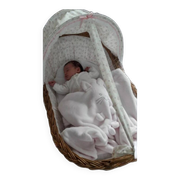Vintage wicker cradle on wheels from the 1970s.