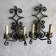 Pair of wall sconces in wrought iron with golden leaf patterns.