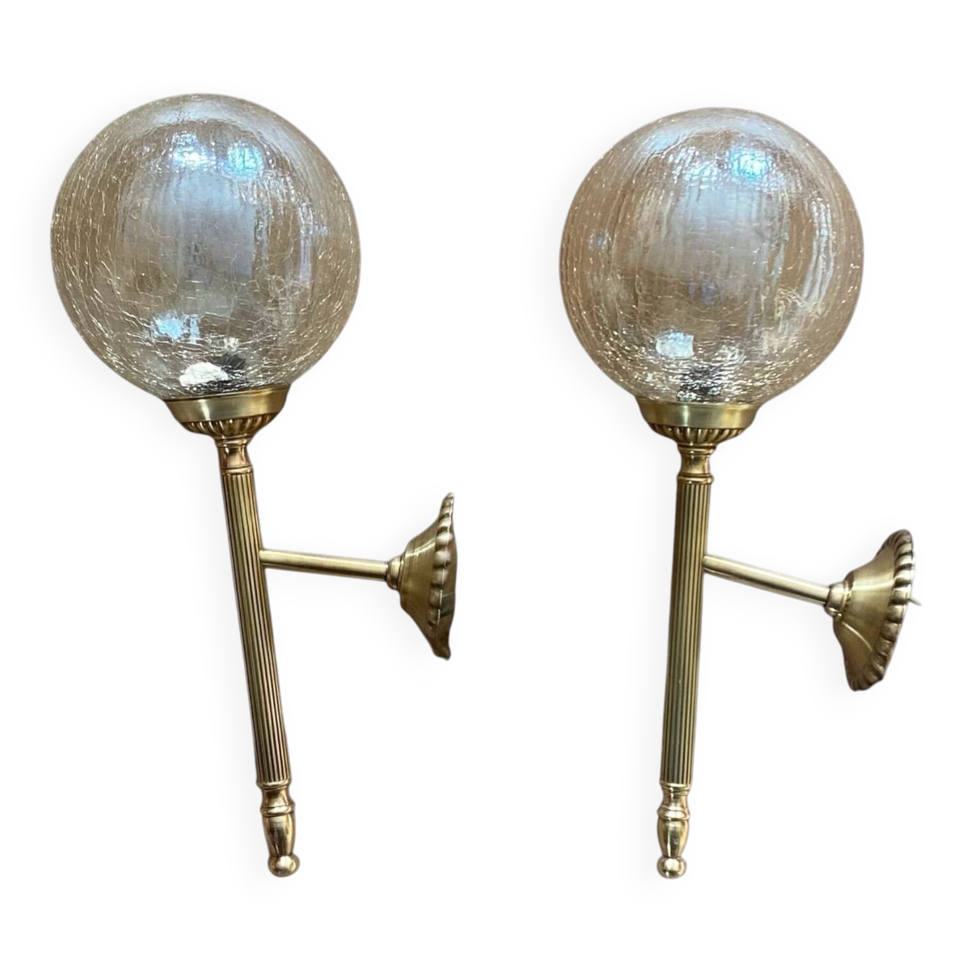 Pair of antique wall sconces torch style brass with glass globes in gold.