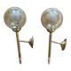 Pair of antique wall sconces torch style brass with glass globes in gold.