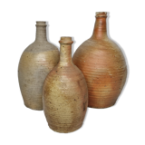 Set of three enamelled terracotta bottles