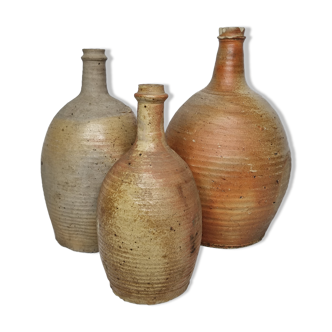 Set of three enamelled terracotta bottles