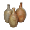 Set of three enamelled terracotta bottles