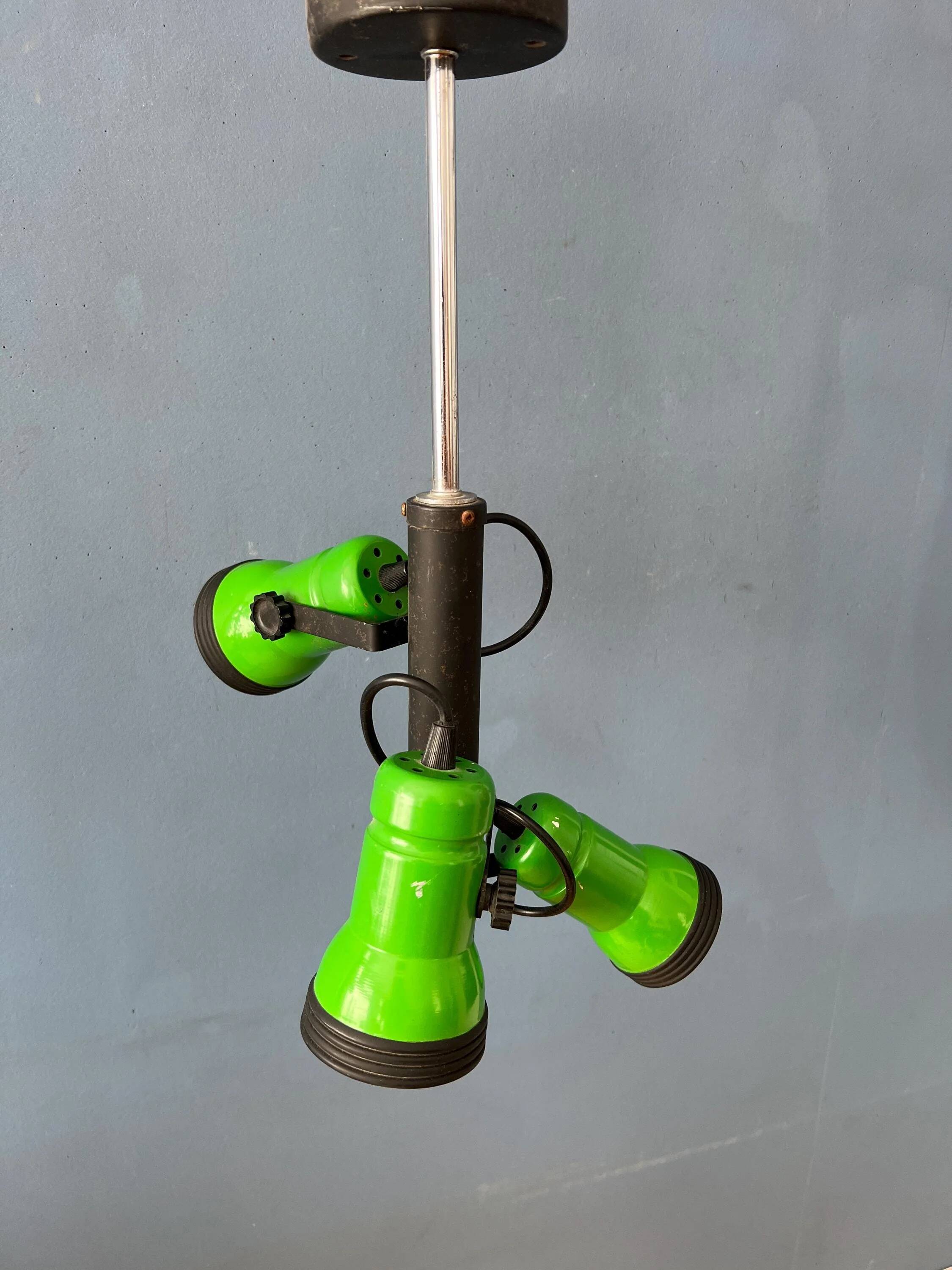 Vintage pendant light with three green spots.