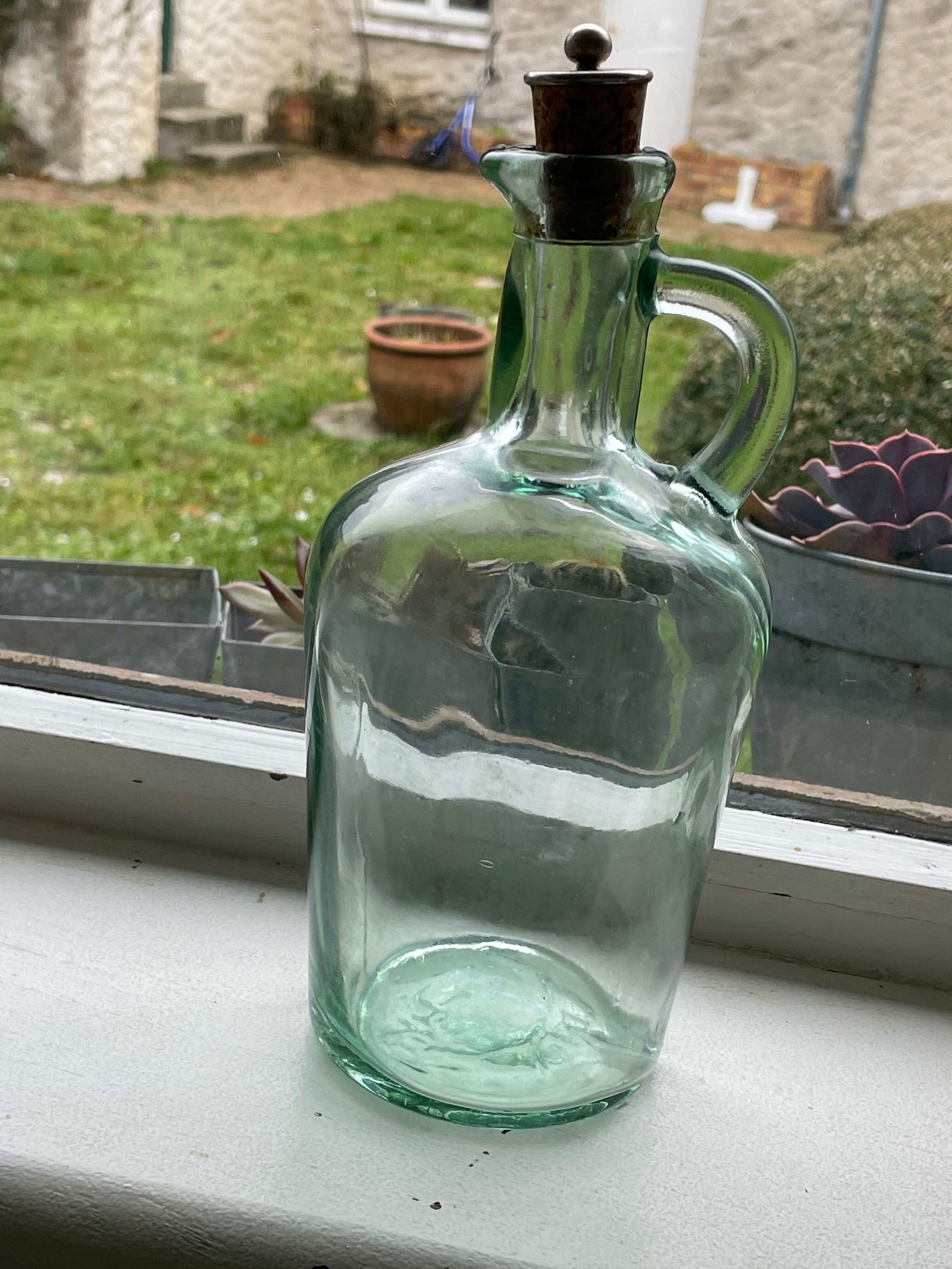 Green pitcher made of vintage glass