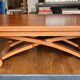 Wooden coffee table convertible into a dining table.