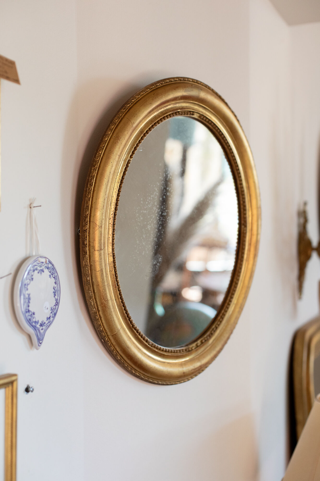 Oval mirror in gilded wood late 19th