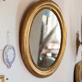 Oval mirror in gilded wood late 19th