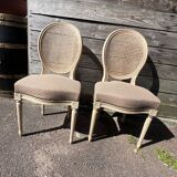 Pair of cerused chairs with fabric seats and caned backs.