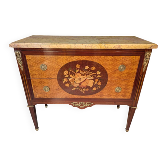 Louis XVI style commode inlaid with a decoration of instruments.
