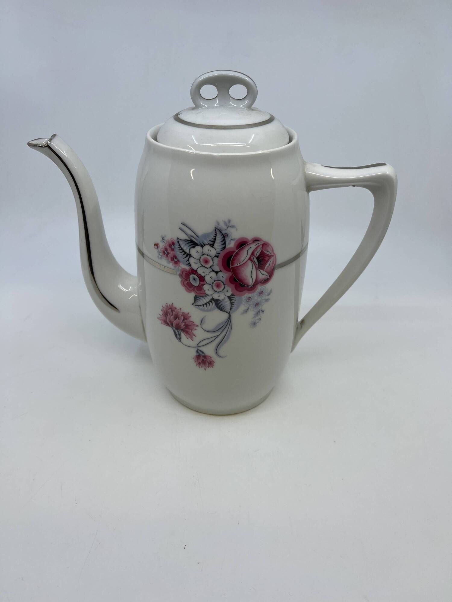 Porcelain coffee service with floral decoration and silver trim.