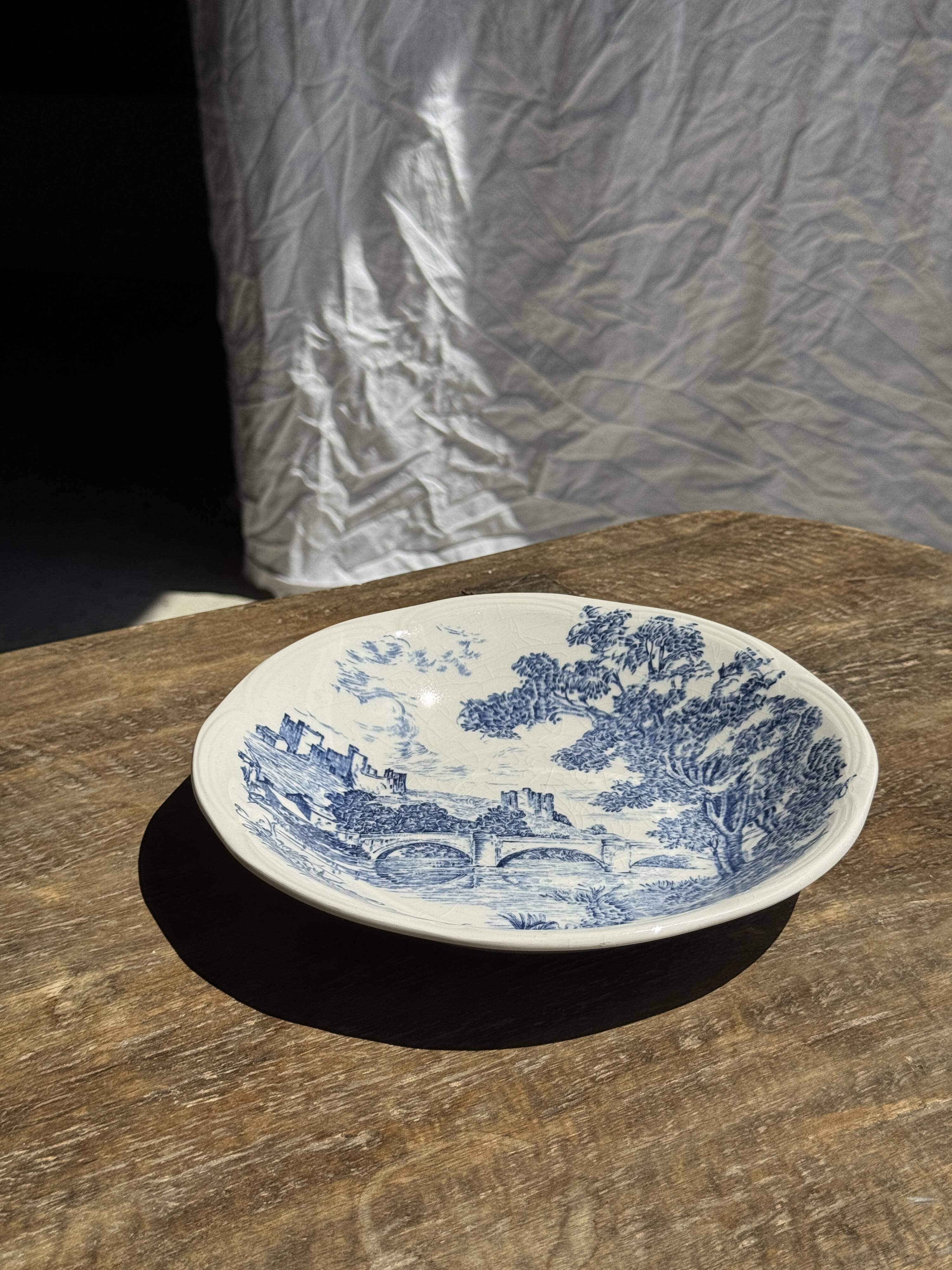 Small deep Gien earthenware plate with blue landscape motif D21.5