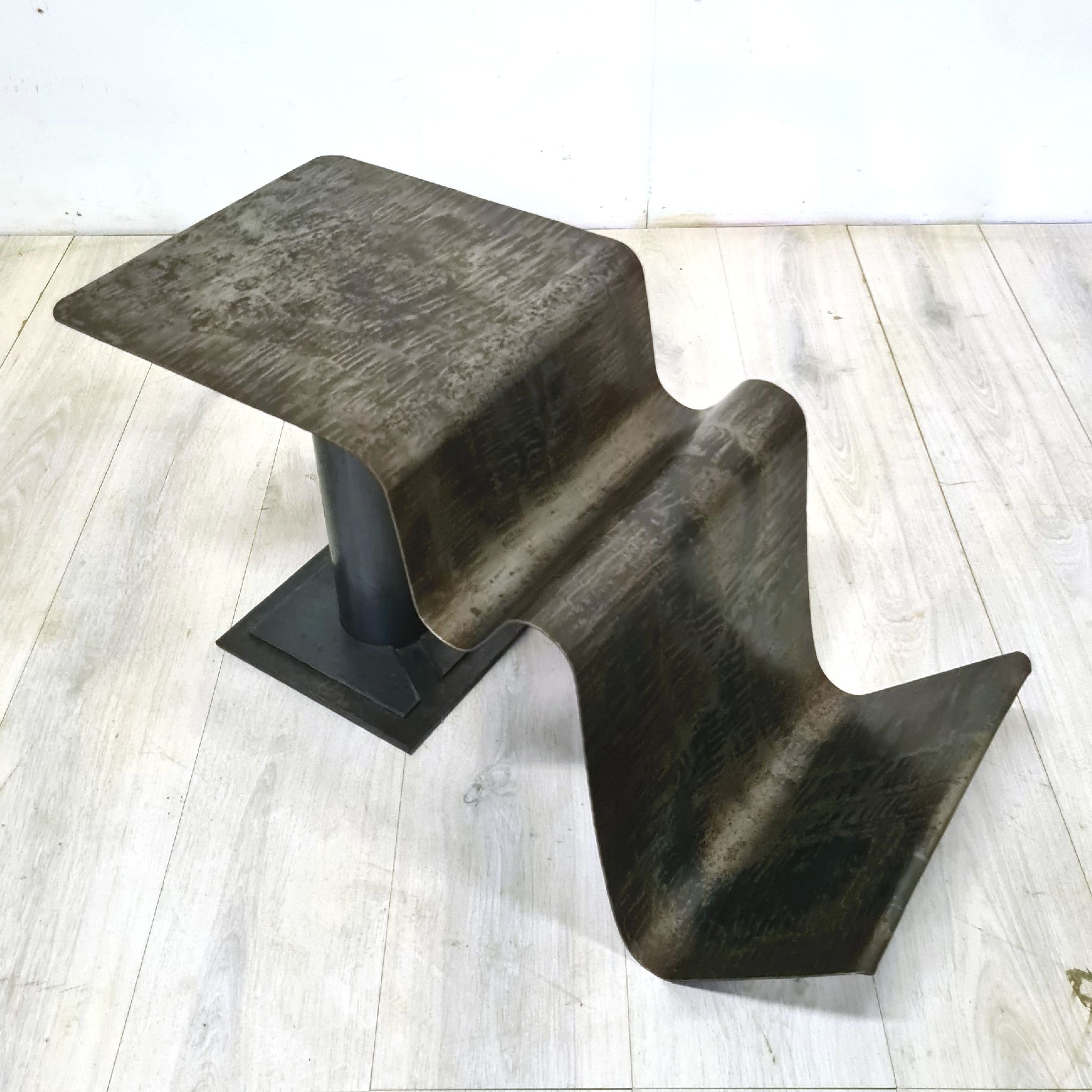 Curved sheet metal side table with magazine stand, 1980s