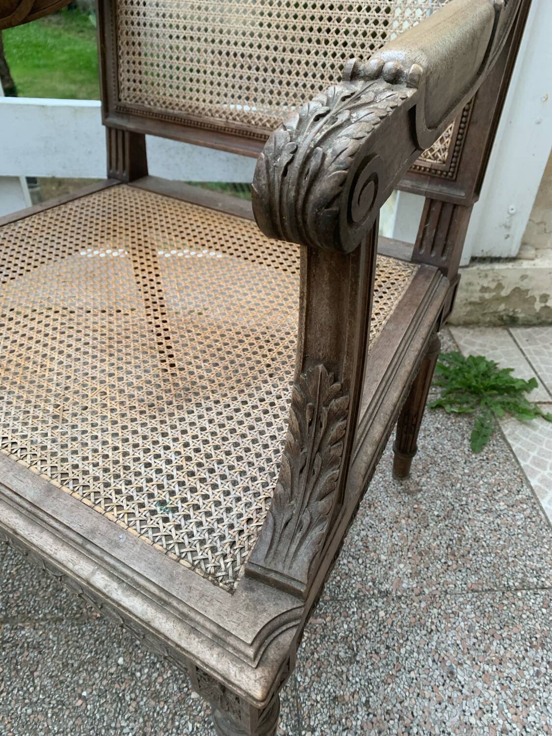 Wooden armchair with caning in Louis XVI style