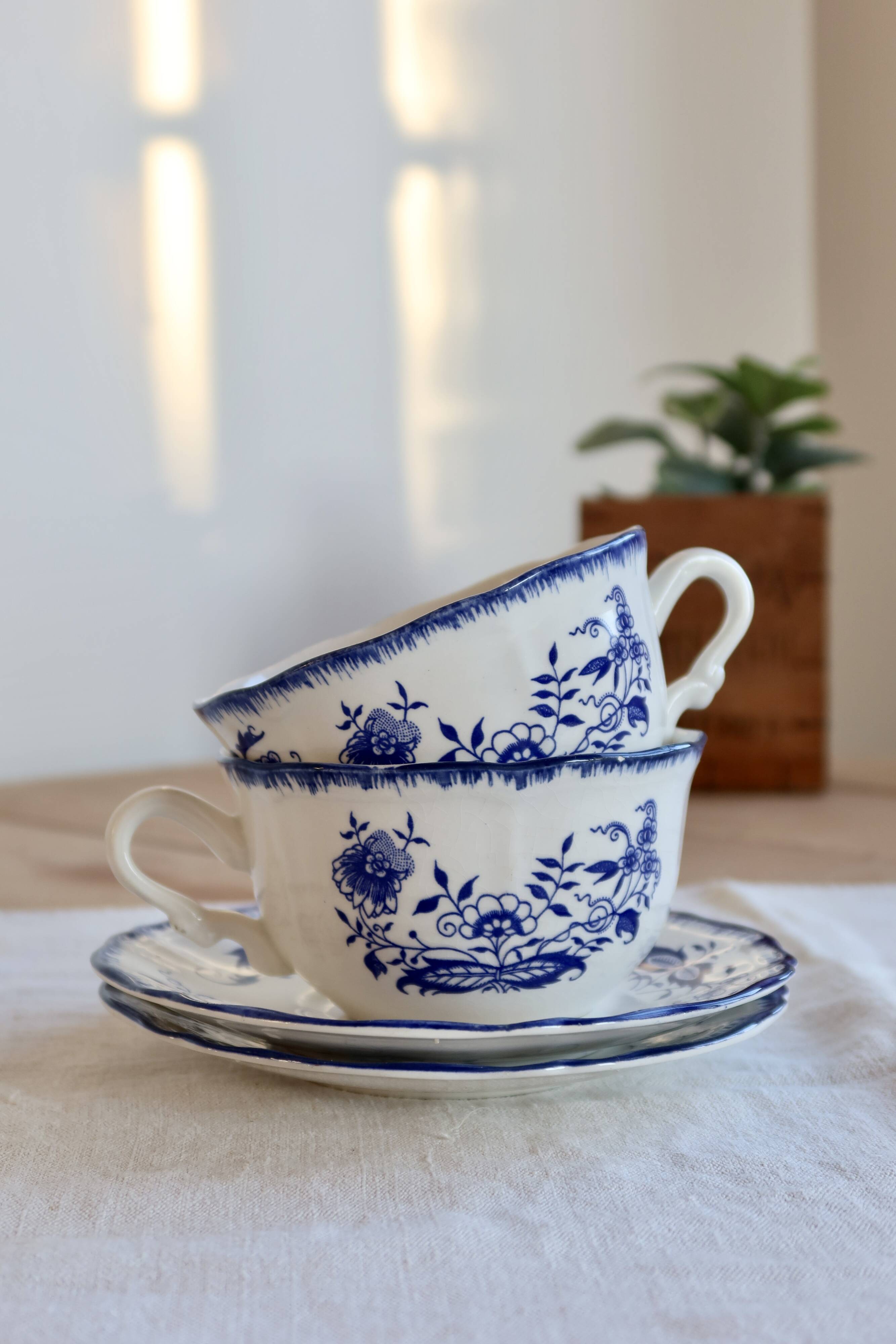 Old Lancaster cups and saucers in white earthenware with blue decoration.