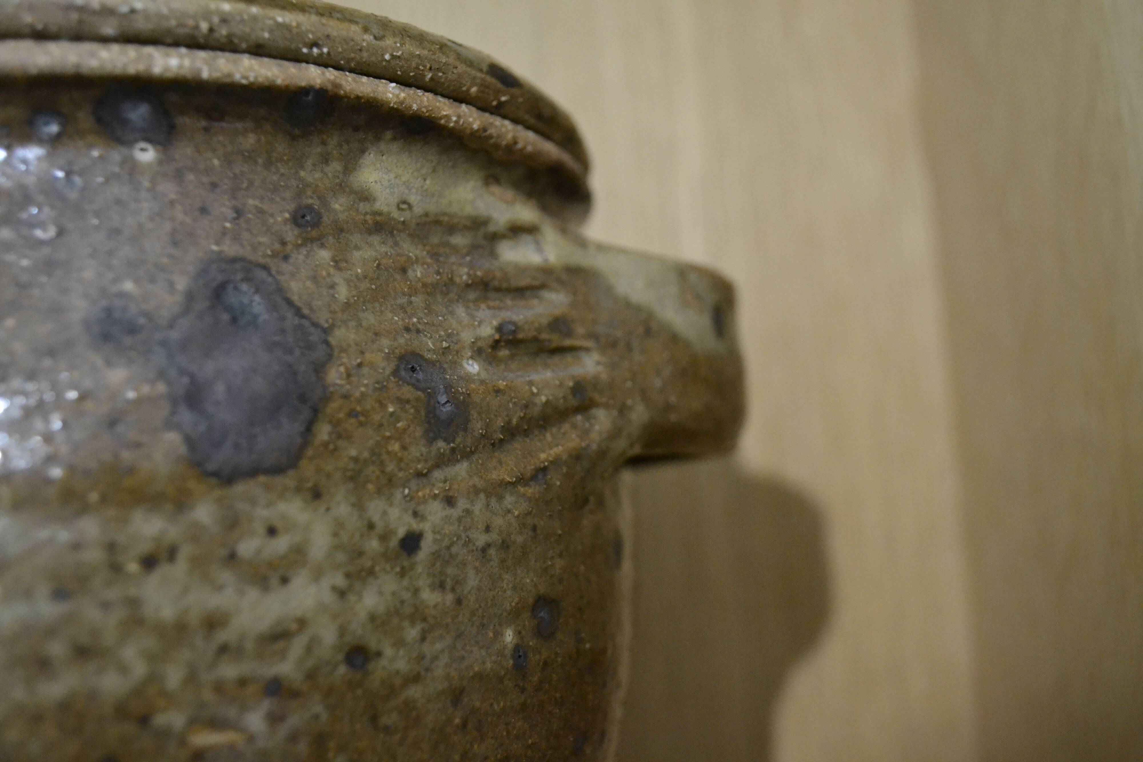 Sandstone pot with handles hands