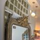 Long trapezoidal mirror in gilded brass, curved Art Deco modernist.