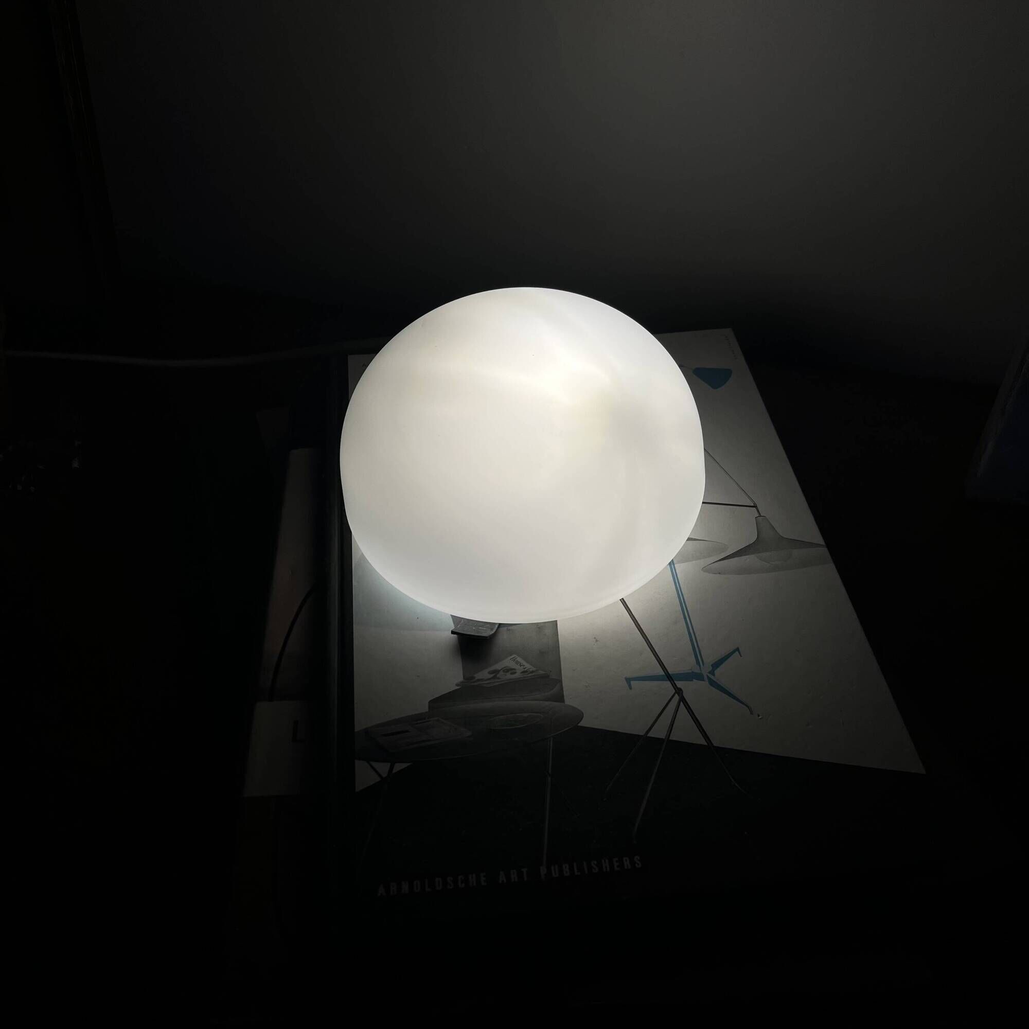 Small antique ceiling light or wall sconce with a frosted white glass half-moon.