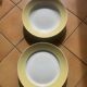 Two earthenware dishes, one hollow and one white cake dish with yellow border