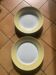 Two earthenware dishes, one hollow and one white cake dish with yellow border