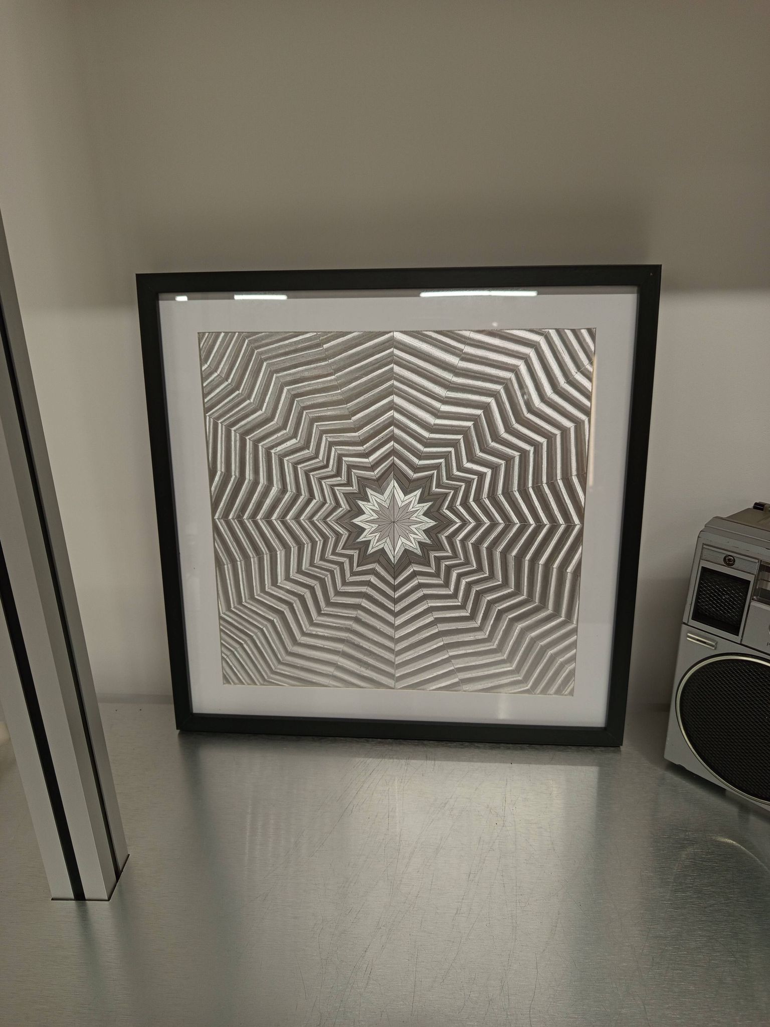 a Kinetic Op Art Aluchromy under glass frame.