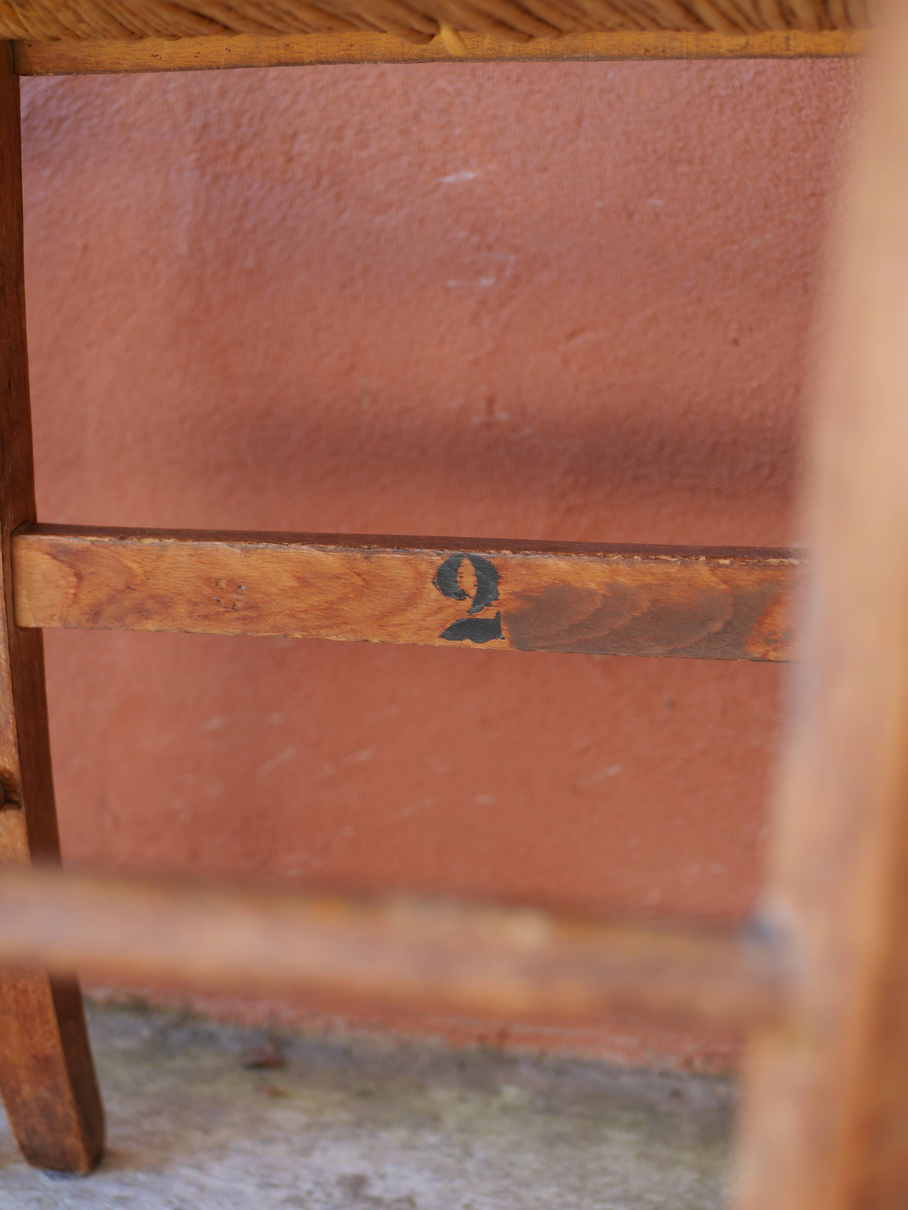 Set of 5 mismatched straw chairs.