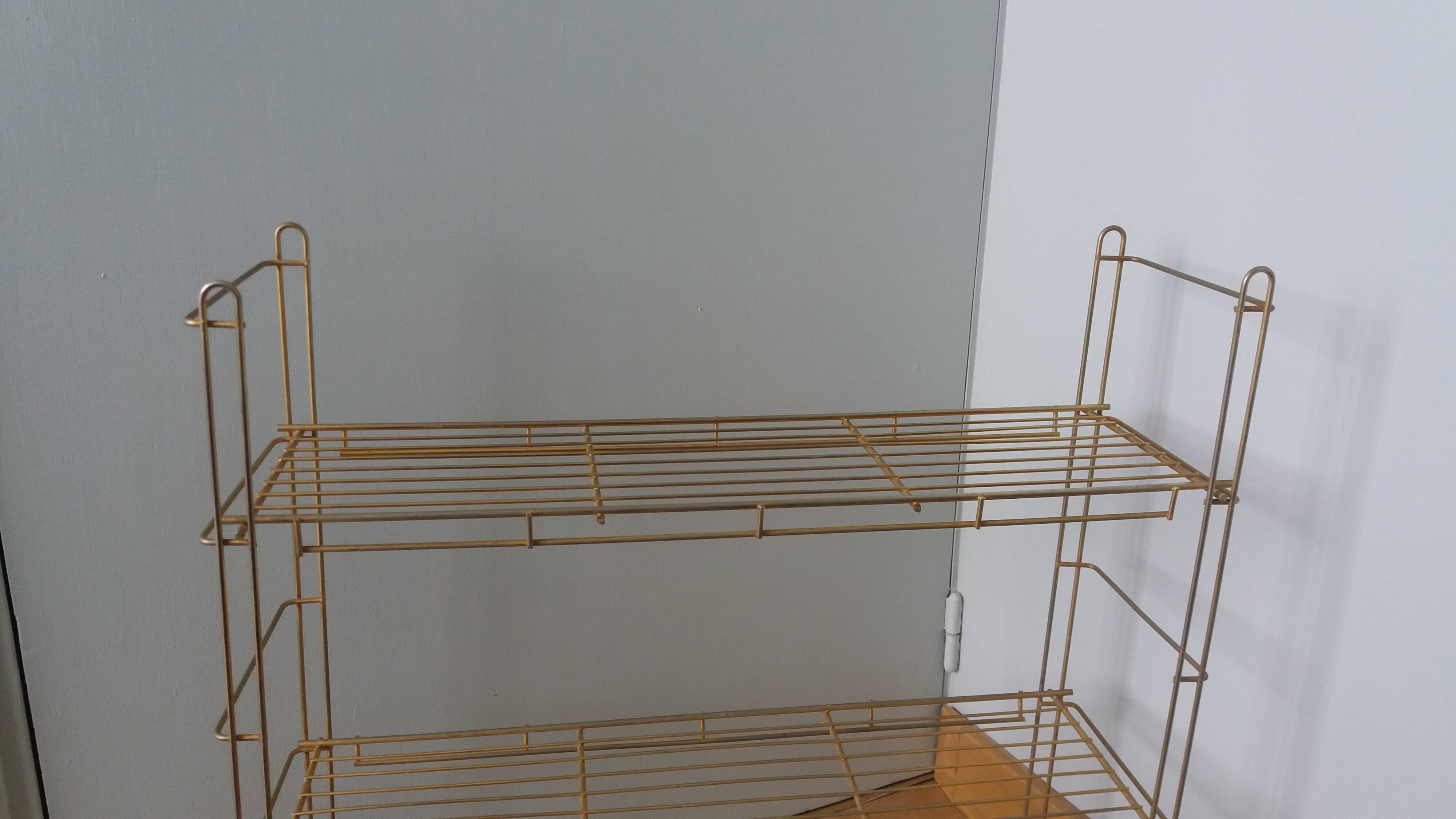 String shelf in golden metal wires
