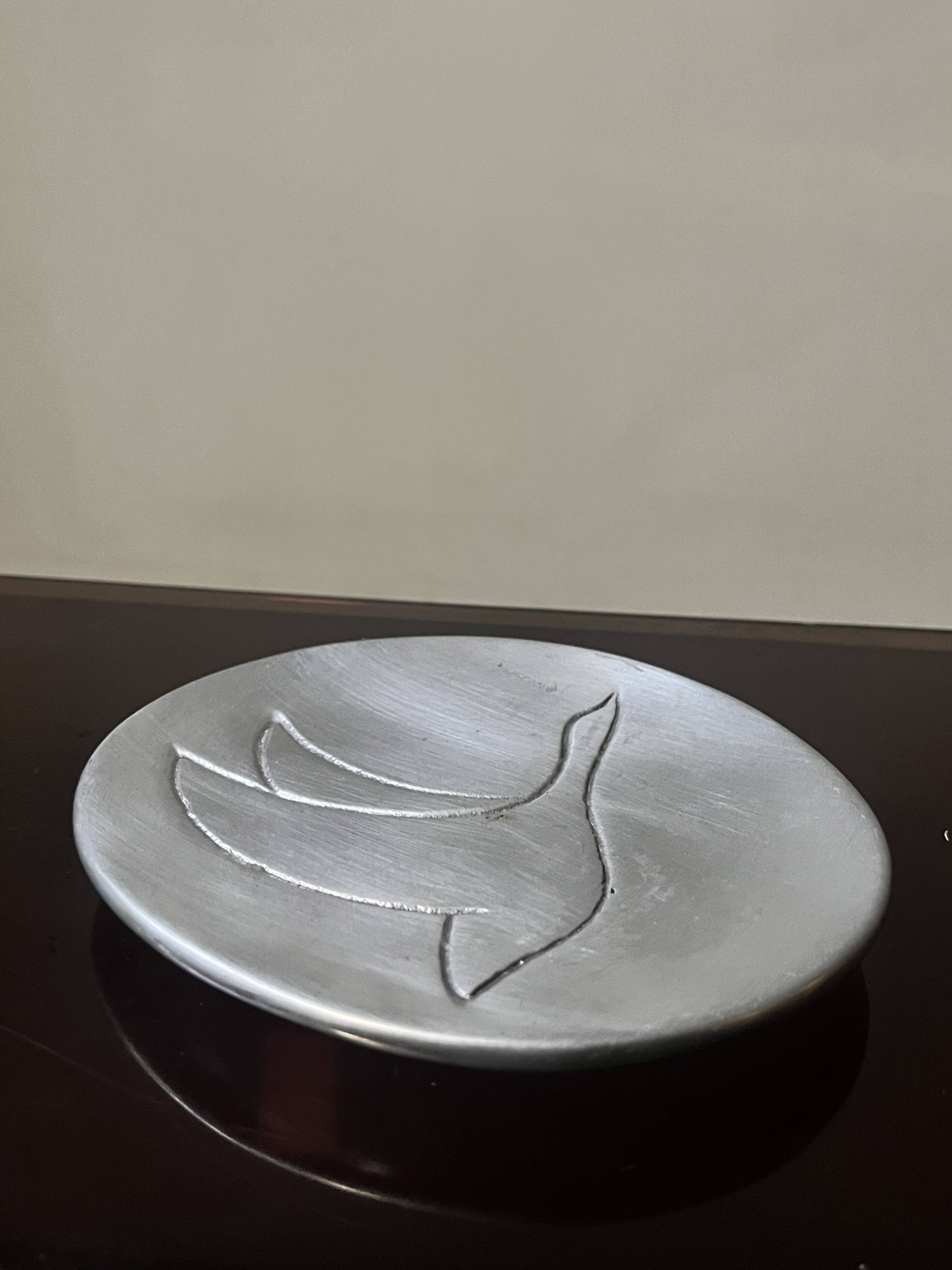 polished aluminum pocket emptier, signed and stamped in the mass