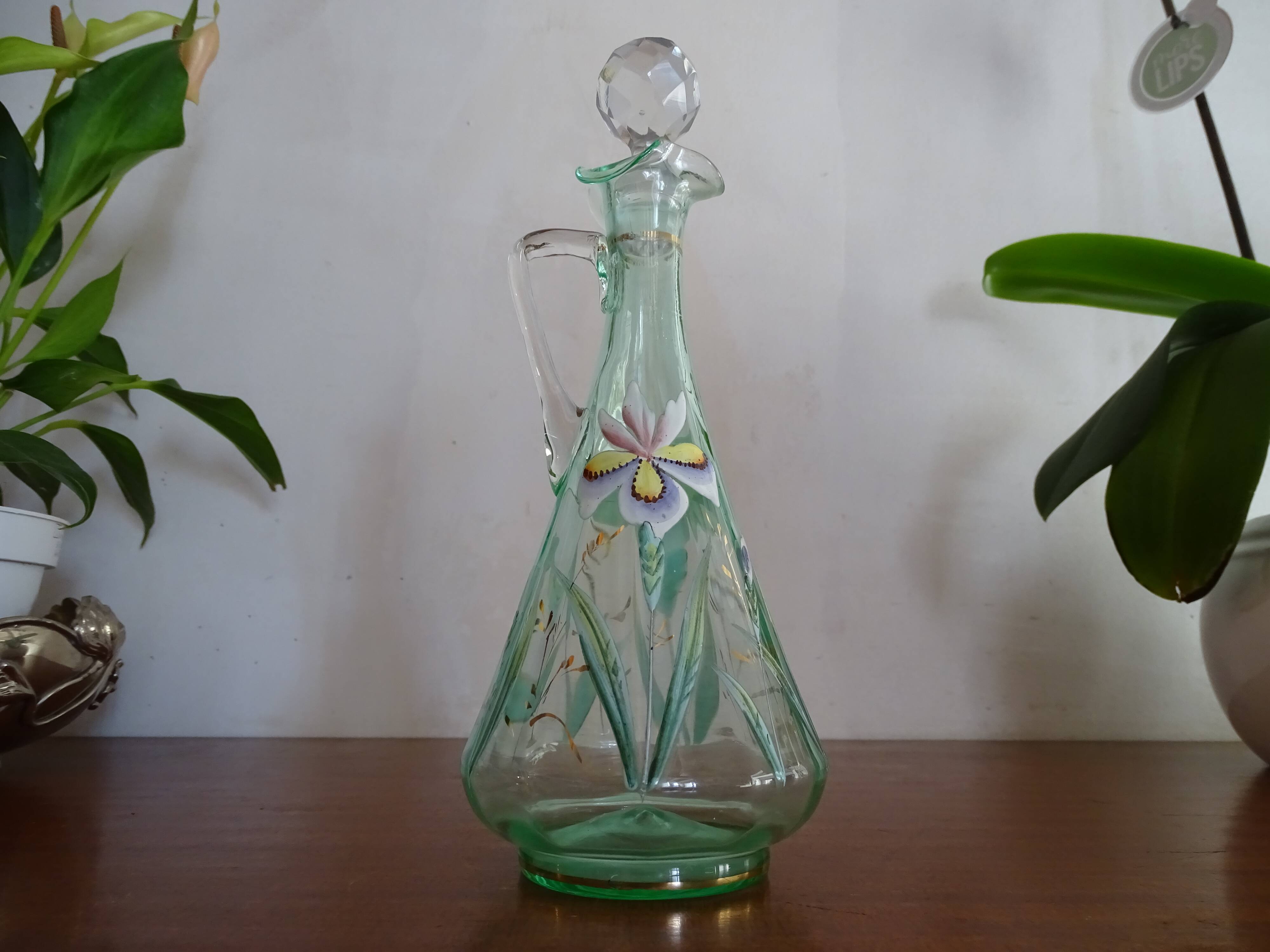 Old carafe enamelled with glass flowers
