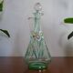 Old carafe enamelled with glass flowers