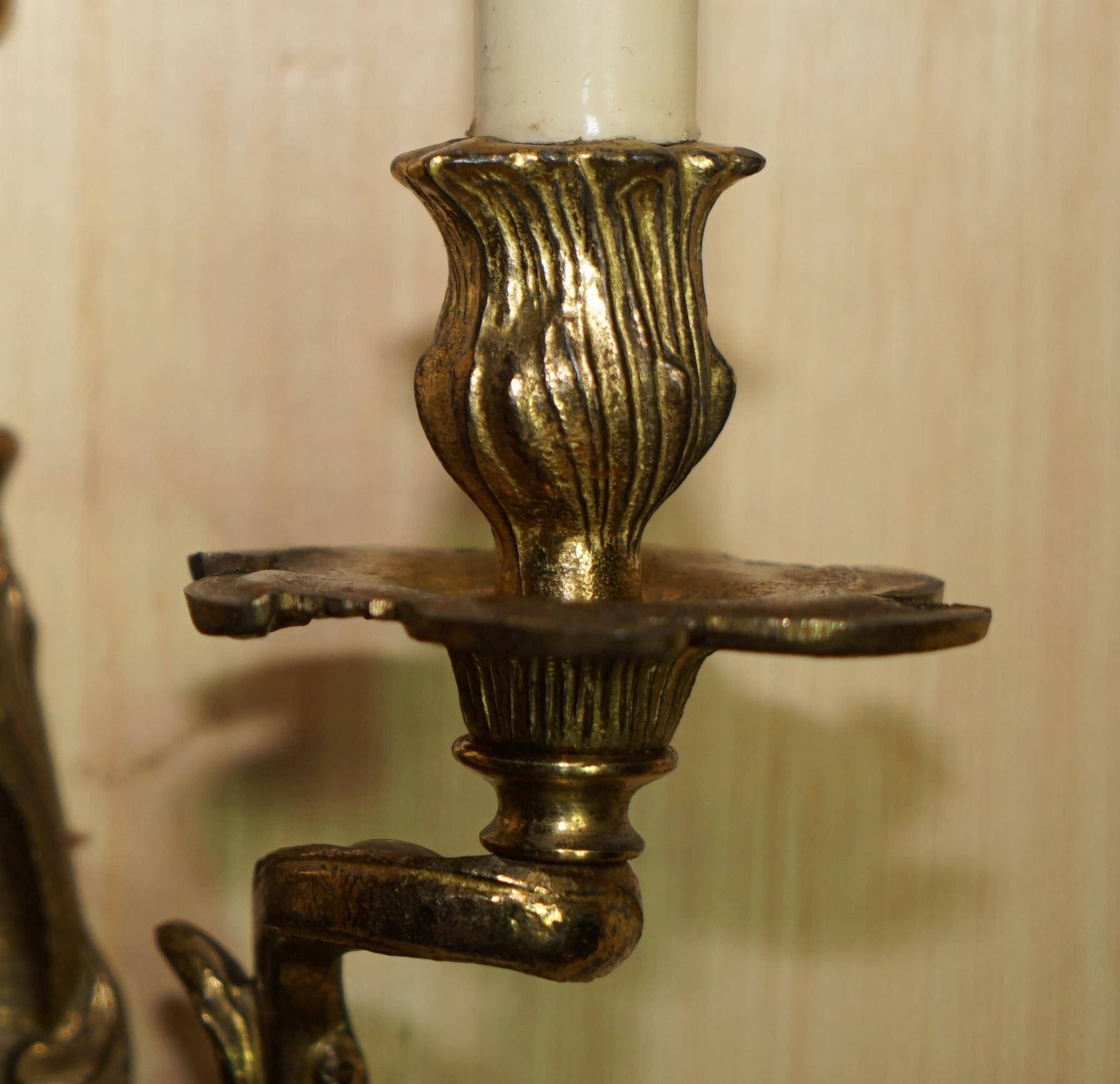 Pair of antique wall sconces from the 1920s in gilded bronze.