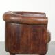Sheepskin clubarmchair with beautiful patina finished with decorative nails