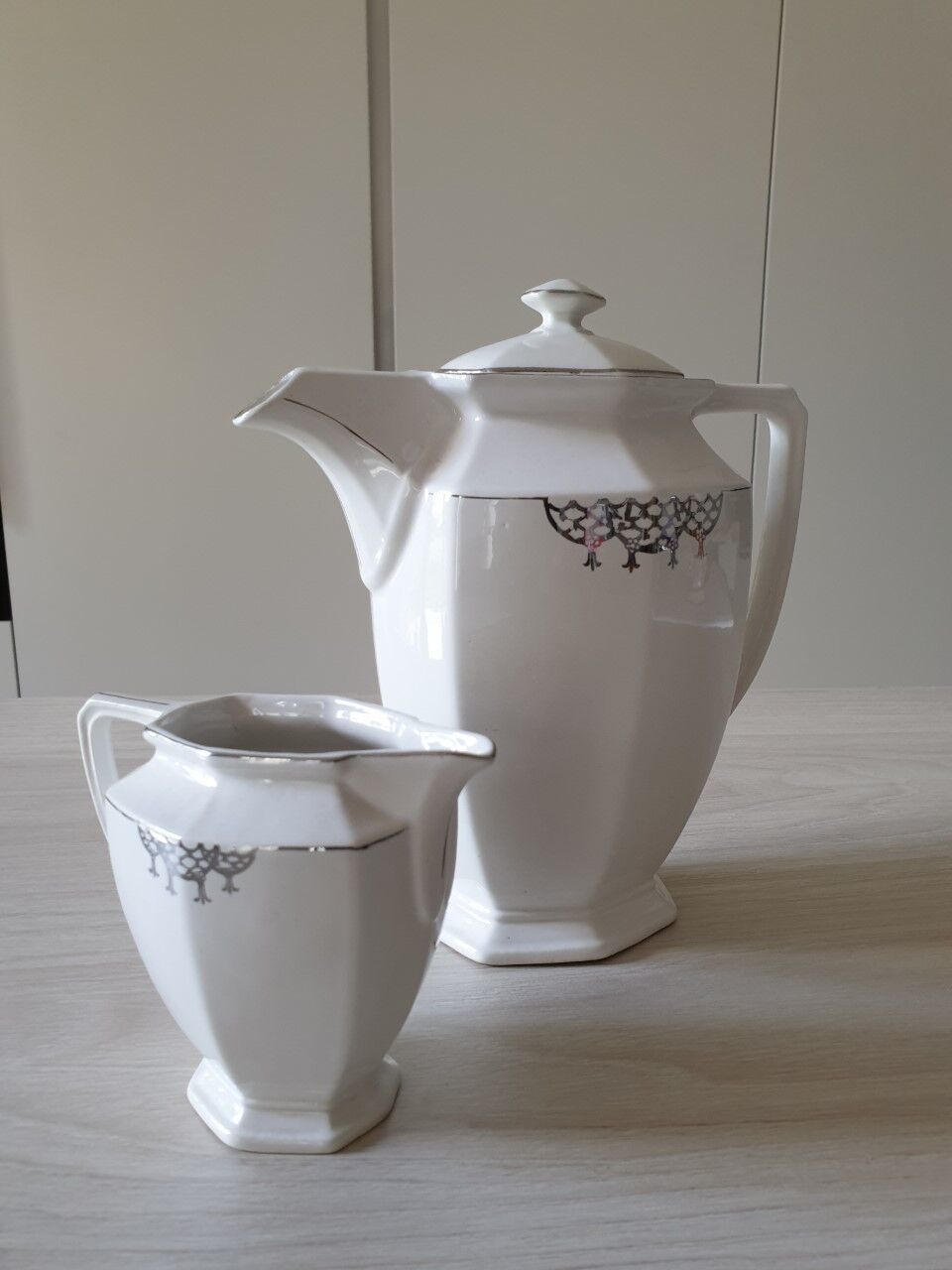 Old coffee maker and its milk pot